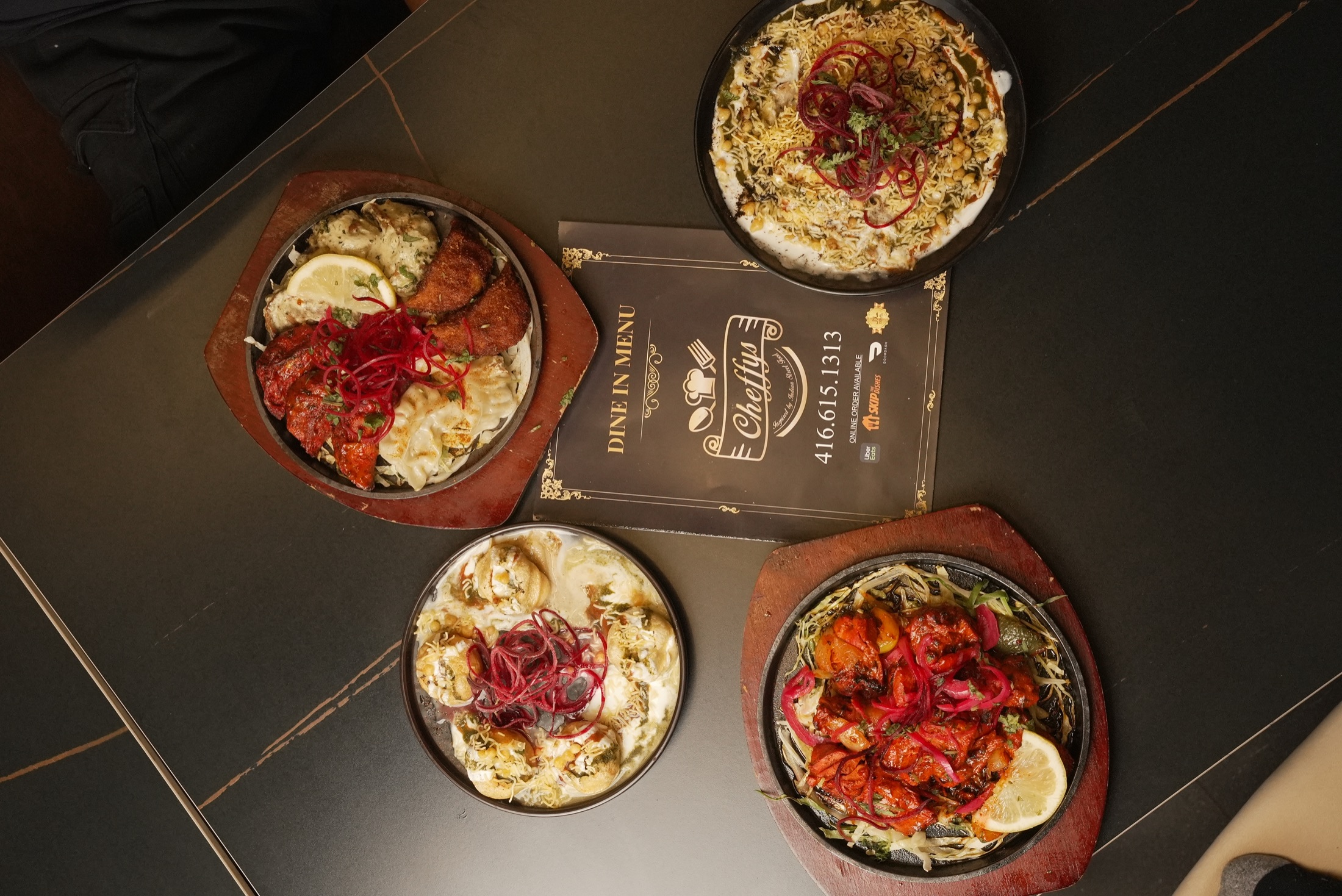 Overhead spread of Cheffys Indian street food dishes