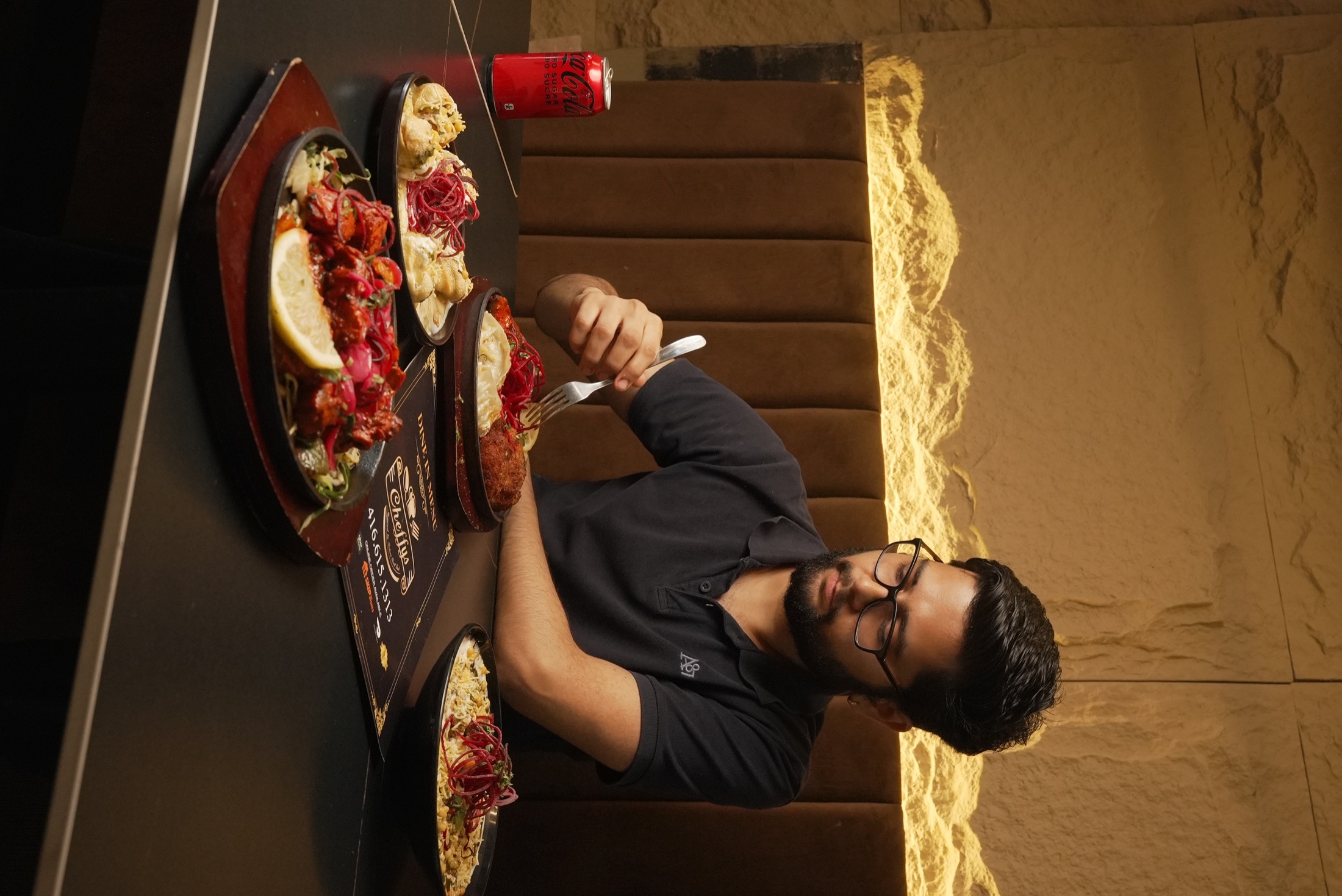 Guest dining at Cheffys with a table full of dishes