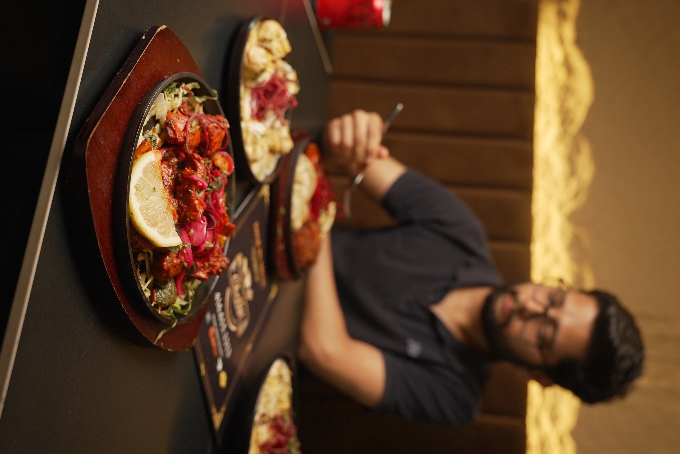 Cheffys dish in focus with a guest dining behind it