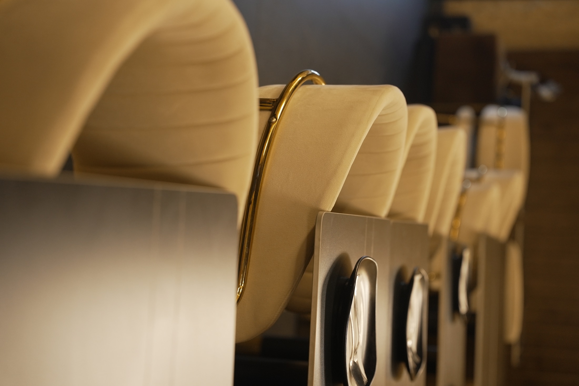 Neutral seating and gold details at Cheffys